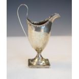 George III silver cream jug having a high loop handle and standing on a square foot, London 1791,