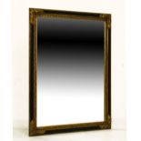 Large reproduction gilt and black framed wall mirror, overall dimensions 140cm x 109cm Condition: