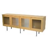 Ikea birch finish side board fitted four glazed doors and standing on tubular supports Condition: