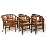 Set of four mahogany tub shaped elbow chairs, each having a split seat and back and standing on