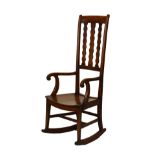 Late 19th century mahogany rocking chair having a high triple wavy lathe back, open scroll arms,