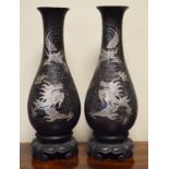 Pair of Chinese black lacquered baluster shaped vases having silvered decoration depicting dragons