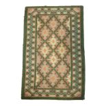 1930's period wool rug having geometric decoration on a grey ground within a green ground multi