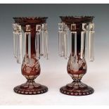 Pair of bohemian ruby flash glass lustre drop vases, each having engraved grapevine decoration