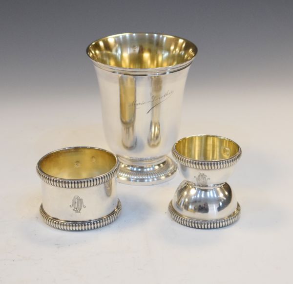 Three items of French silver comprising: a footed christening cup, a napkin ring of heavy gauge