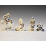 Four Lladro figures comprising: Eskimo Playing, Eskimo Boy With Pet, Eskimo Riders and A Cheerful