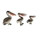 Three graduated silver and enamel models of pelicans, the birds each with enamel to beak, Sheffield,