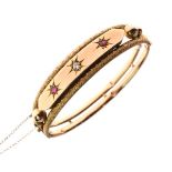 Antique yellow metal hinged bangle set with diamond and ruby coloured stones, stamped 9ct, 12.4g