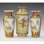 Pair of Chinese porcelain vases, each decorated with a Kylin in a landscape on a floral patterned