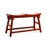 Chinese red finish stool standing on splayed square supports united by stretchers Condition: