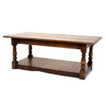 Reproduction style oak rectangular topped coffee table standing on turned supports united by a
