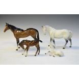 Four Beswick horse figures comprising: Grey Mare No.976, Grey Foal No.947, Brown Racehorse No.701