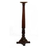 Victorian mahogany torchère having a circular top, octagonal and carved pillar and standing on a