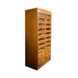 Vintage beech haberdasher's cabinet fitted sixteen glass fronted drawers with four drawers below,