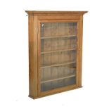 Stripped pitch pine display cabinet fitted five shelves enclosed by a glazed door Condition: