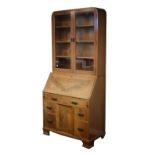 1930's period mahogany bureau bookcase, the upper section fitted four shelves enclosed by a pair