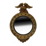 Old reproduction Regency style circular convex wall mirror typically surmounted with an eagle