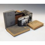 Two vintage Kodak Brownie box cameras, a vintage Ilford camera and two empty vintage photograph