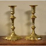 Pair of mid 18th Century brass candlesticks, each having a double knopped stem and standing on a