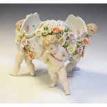 Large Dresden style porcelain figural table centre formed as a floral encrusted bowl supported by