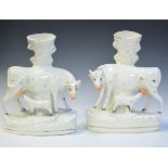 Pair of 19th Century Staffordshire pottery figural vases, each formed as a cow and calf and having