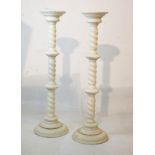 Pair of off-white painted torchères, each standing on a knopped barley twist column and circular