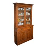 Edwardian oak two section bookcase, the upper section fitted four shelves enclosed by a pair of