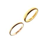 Two yellow metal wedding bands, the first 22ct gold, size M½, the second size N indistinctly marked,