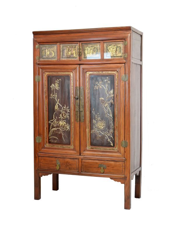 Chinese cupboard having a moulded cornice, two narrow doors below, each fitted two glazed carved