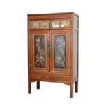 Chinese cupboard having a moulded cornice, two narrow doors below, each fitted two glazed carved