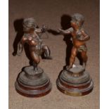 Pair of late 19th/early 20th Century French bronzed spelter figures, each depicting a cherub