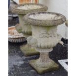 Pair of modern 'stone' garden urns, each having mask head decoration Condition: