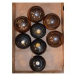 Set of four vintage lignum vitae bowling woods, together with another set of vintage bowling woods