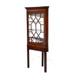 George III mahogany corner cabinet fitted four shelves enclosed by an astragal glazed door, the