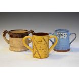 Exeter Art Pottery two handled cider mug decorated with stylised foliage and motto 'If ye can't be