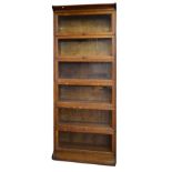 Early 20th Century oak six tier sectional bookcase having typical glazed up-and-over doors, together