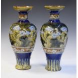 Pair of Doulton Lambeth stoneware baluster shaped vases having typical stylised foliate decoration