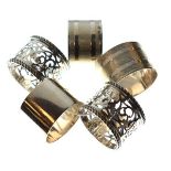Five assorted silver napkin rings comprising: two pairs, the first with banded decoration,