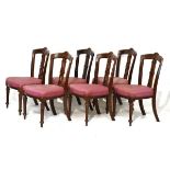 Set of six late Victorian carved walnut dining chairs, each having a stuffed seat and standing on