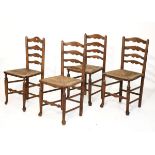 Set of four 19th Century country made ash ladder back side chairs, each having a rush seat and