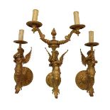 Set of three gold painted metal Renaissance style figural wall lights, each formed as a winged