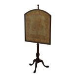 19th Century mahogany polescreen, having a tapestry panel with floral decoration, standing on a