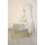 Early 20th Century iron framed rocking crib with drapes Condition:
