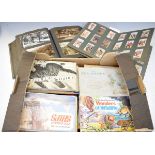 Various cigarette cards, trade cards and postcards, all in albums Condition:
