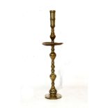 Large brass and bronze altar candlestick with turned socket and dished drip tray on turned stem,