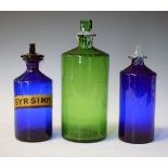 Three chemists or apothecary bottles comprising two in blue glass, one labelled SYR:SIMPLE
