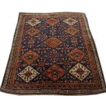 Middle Eastern rug having geometric decoration on a blue and red ground within multi borders,