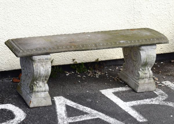 Reconstituted stone garden bench on scroll supports Condition: