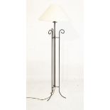 Metal standard lamp of tubular design with central stem between three scroll supports Condition: