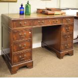 20th Century mahogany twin pedestal writing desk with gilt and blind tool skiver over cock beaded